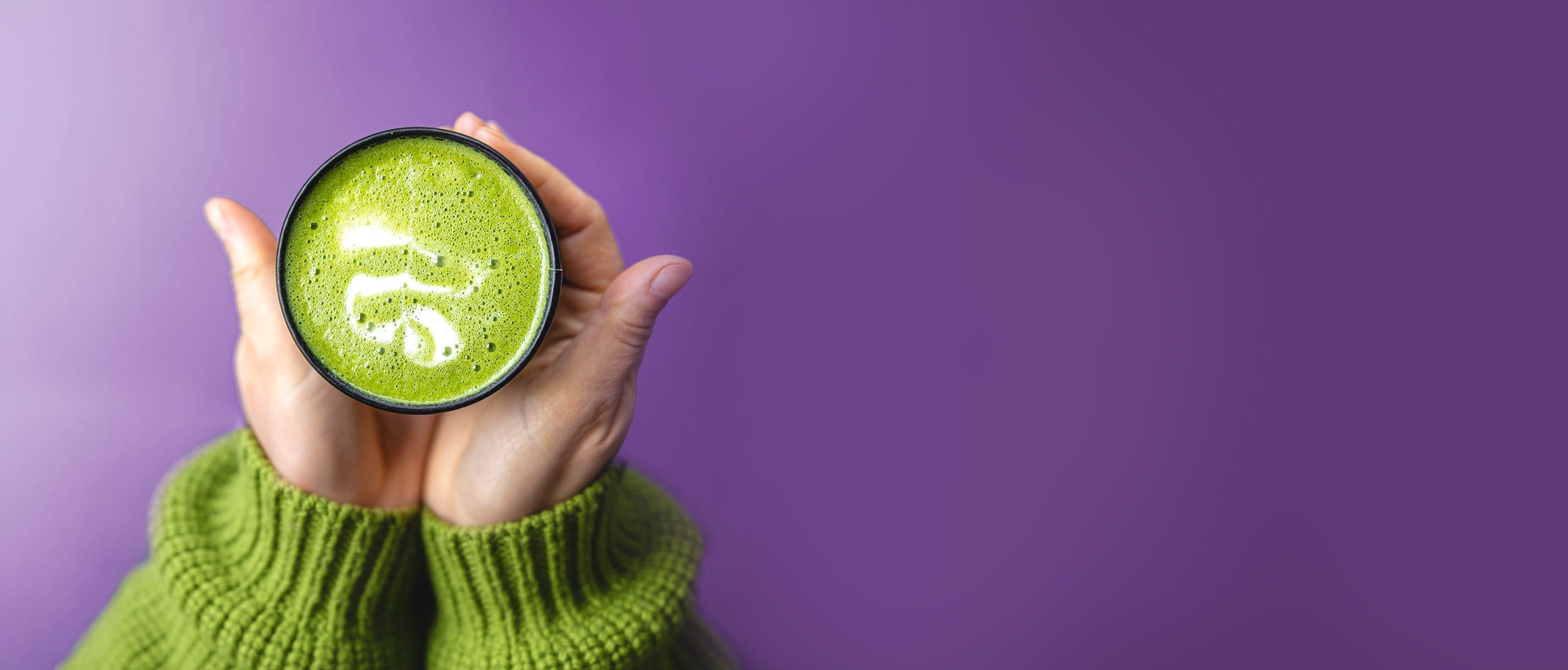 Hands holding a cup of matcha